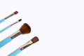 Set of four makeup brushes on a white background