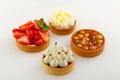 Set of four mini tart with raspberry berries, cream and hazelnut Royalty Free Stock Photo