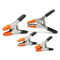 Set of Four Orange and Black Spring Clamps on White Royalty Free Stock Photo
