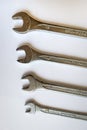 Set of four silver wrenches or spanners of different sizes, isolated on white background. Royalty Free Stock Photo