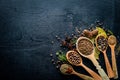 A set of fragrant spices. A mixture of black and red pepper, coriander, paprika. On Wooden background. Royalty Free Stock Photo