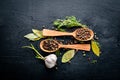 A set of fragrant spices. A mixture of black and red pepper, coriander, paprika. On Wooden background.