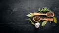 A set of fragrant spices. A mixture of black and red pepper, coriander, paprika. On Wooden background.