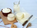 Set of fresh dairy products on wooden background: milk, cheese, cottage yogurt egg mozzarella, ryazhenka, feta. Royalty Free Stock Photo