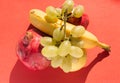 Top view of Set of fresh fruits: golden apple, banana, pomegranate and grapes