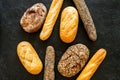 Set of fresh homemade bread. Bread assortment. Loaf, baguette. White and brown bread on black background top view Royalty Free Stock Photo