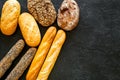 Set of fresh homemade bread. Bread assortment. Loaf, baguette. White and brown bread on black background top view copy Royalty Free Stock Photo