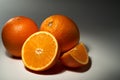 Set of fresh oranges. Two whole oranges, one half and one quarter. Royalty Free Stock Photo