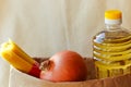 A set of fresh products in a paper bag: a bottle of oil, pasta, onions. Bag food concept Royalty Free Stock Photo