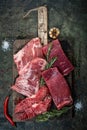 Set of fresh raw alternative beef steaks on a wooden Board: Denver, Skirt, Flank, Machete