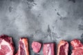 Set of Fresh raw marbled beef steaks, tomahawk, t bone, club steak, rib eye and tenderloin cuts, on gray stone background, top Royalty Free Stock Photo