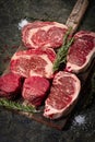 Set of Fresh raw marbled beef steaks on a wooden Board: tenderloin, Striploin, ribeye