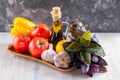 Set of fresh raw vegetables. Tomato, bell pepper, garlic, basil and lemon on a wooden tray. Healthy eating. Organic food Royalty Free Stock Photo