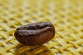 Set of fresh roasted macro coffee beans, yellow wicker basket background. Royalty Free Stock Photo