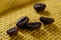 Set of fresh roasted macro coffee beans, yellow wicker basket background Royalty Free Stock Photo