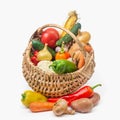 A set of fresh vegetables in a wicker basket on a white isolated background. Harvesting vegetables and fruits in summer and autumn Royalty Free Stock Photo