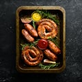 Set of fried barbecue sausages with rosemary and sauces. Royalty Free Stock Photo