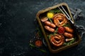 Set of fried barbecue sausages with rosemary and sauces. Royalty Free Stock Photo