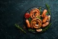 Set of fried barbecue sausages with rosemary and sauces. Royalty Free Stock Photo