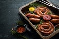 Set of fried barbecue sausages with rosemary and sauces. Royalty Free Stock Photo