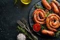 Set of fried barbecue sausages with rosemary and sauces. Royalty Free Stock Photo