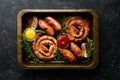 Set of fried barbecue sausages with rosemary and sauces. Royalty Free Stock Photo