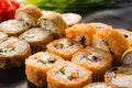 Set of fried sushi rolls with wasabi and ginger on black background. Japanese oriental cuisine Royalty Free Stock Photo