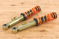 Set of front shock absorbers on the wooden table, 3D rendering Royalty Free Stock Photo