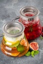 Set of fruit and berry teas with figs, raspberries and lemon. Various teas on gray table. Vertical composition Royalty Free Stock Photo