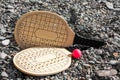 Set for game of beach tennis on background di pabble beach. Wooden rackets on the beach in summer sunny day Royalty Free Stock Photo