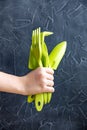 A set of gardening tools light green colors in hand on a black background.