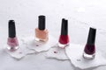 Set of glass bottles of nail polish on the pieces of paper Royalty Free Stock Photo