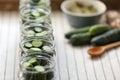 Set of glass jars with fresh cucumbers prepared for canning on table, closeup. Space for text Royalty Free Stock Photo