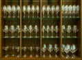 Set of glasses for different alcoholic drinks and cocktails on wood shelf background Royalty Free Stock Photo