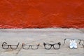 Set of glasses on the pavement that refers to a complete family that wears glasses