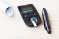 Set glucometer and syringe with Diabetes Indicator Strips For Blood Glucose Testing on wood background Royalty Free Stock Photo