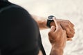 Set goals then crush them. an unrecognizable man checking his watch while out for a workout.