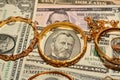 A set of gold accessories of rings, chains and bracelets on American dollars banknotes money of different values Royalty Free Stock Photo