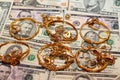 A set of gold accessories of rings, chains and bracelets on American dollars banknotes money of different values