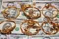 A set of gold accessories of rings, chains and bracelets on American dollars banknotes money of different values Royalty Free Stock Photo