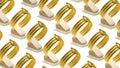 Set of gold bracelets arranged on white stands on a table