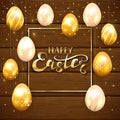Set of golden Easter eggs on brown wooden background Royalty Free Stock Photo