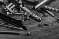 Set of golden screws, bolts, nails, washers, nuts on wooden back Royalty Free Stock Photo