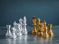 Set of golden and silver chess pieces element, king, queen rook, bishop, knight, pawn standing on hexagon pattern chessboard. Royalty Free Stock Photo