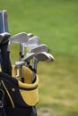 Set of golf clubs over green field Royalty Free Stock Photo