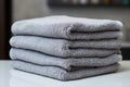 A set of gray towel towers on the shelf