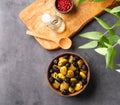 A set of green and black dried olives in bowl on a dark background with olive oil and eucalyptus branch. The concept of vegetarian Royalty Free Stock Photo