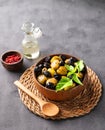 A set of green and black dried olives in bowl on a dark background with olive oil and red pepper. The concept of vegetarian Royalty Free Stock Photo