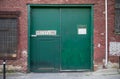 Green doors of a warehouse receiving entrance Royalty Free Stock Photo