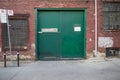 The green doors of a warehouse building